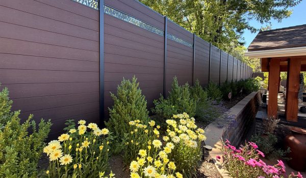 Greenwood Fence Single Ornamental Lattice composite fence in Aspen Brown, a garden
